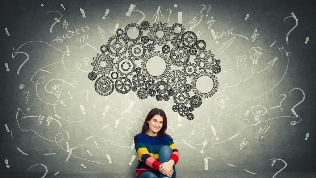 Young woman in a colorful sweater sitting with illustrated gears and question marks around her, symbolizing the mental process of designing an ADHD skincare system that fits her brain.