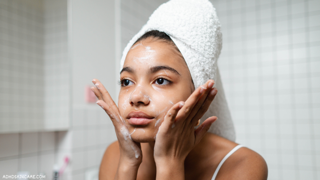 A woman washing her face which is the first step in a 4-step skincare routine for oily skin