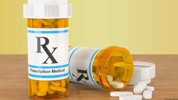 Prescription bottles with spilled pills used to illustrate how Ritalin affects skin health and appearance.