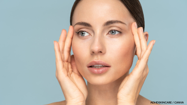 Woman touching face gently, calm sensory moment in ADHD skincare.